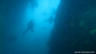 Group of Divers entering a large tunnel